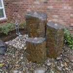 3 pillar water feature with rocks