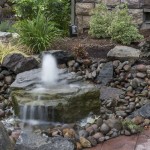 Natural bubbler water feature surrounded by rocks