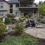 House with landscaping in front, groundcover, plants, rocks