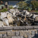 stone retaining wall around water feature